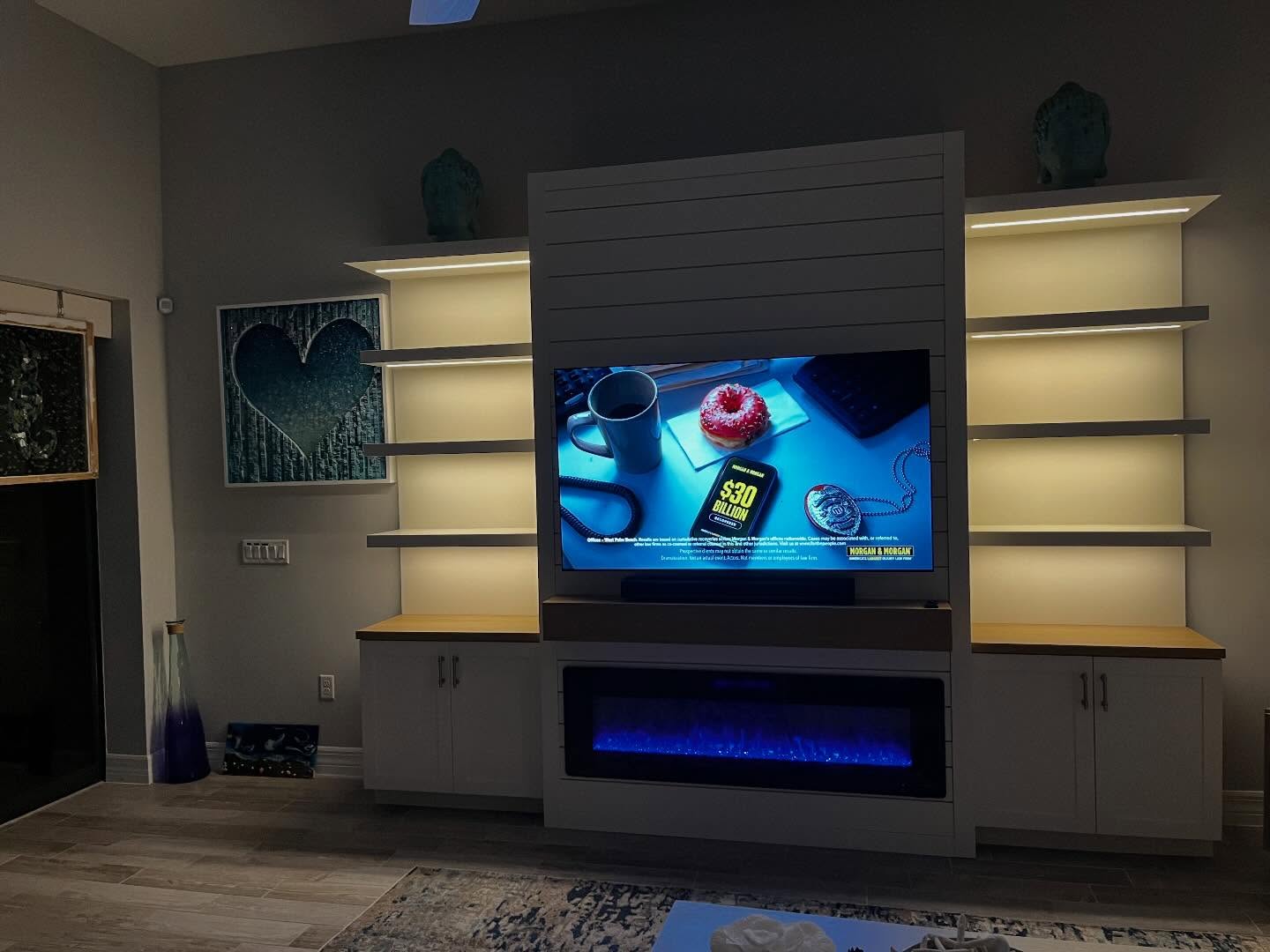 Symmetrical illuminated fireplace and media built-in