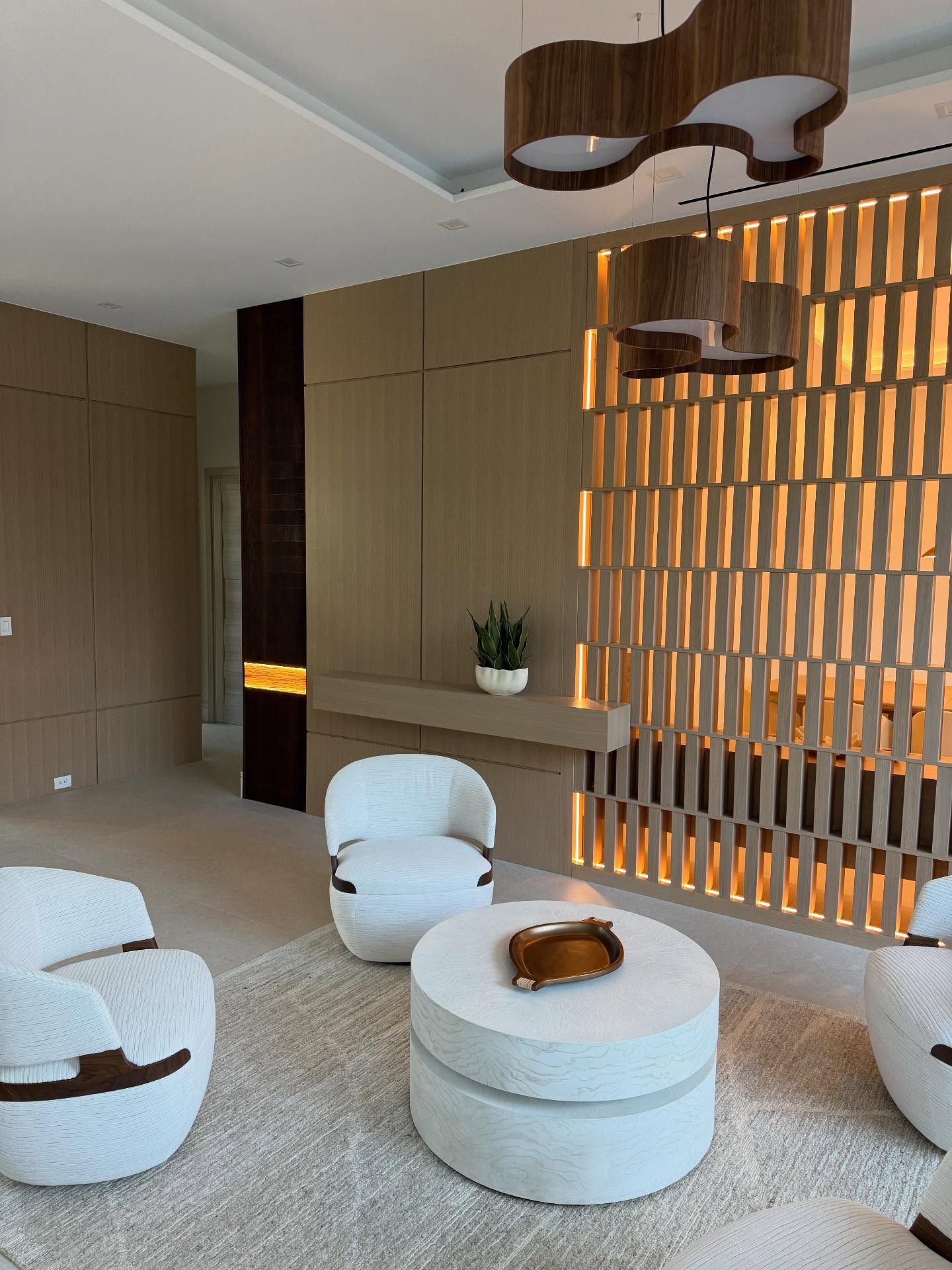 Finished living room with illuminated custom architectural millwork
